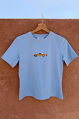 Cadillac Baby T-Shirt in blue stretch cotton with a retro car motif hanging on a wooden hanger.