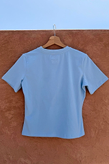 Blue Cadillac Baby T-Shirt back in stretch cotton with tonal embroidery, hanging on a wooden hanger.