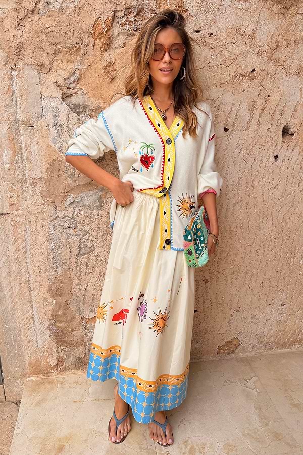Celestial Talia Skirt in breathable cotton with a sun and palm print and blue border, paired with a matching cardigan.