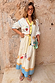 Celestial Talia Skirt in breathable cotton with a sun and palm print and blue border, paired with a matching cardigan.