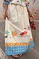 Celestial Talia Skirt in cream cotton with sun and palm motifs and a blue border featuring stars and eye designs.