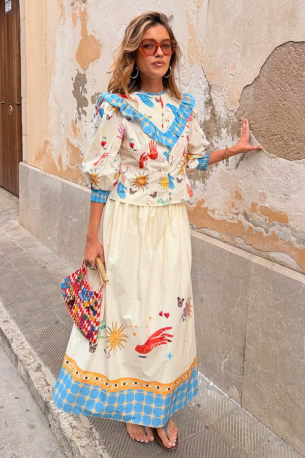 Celestial Talia cotton skirt featuring a sun and palm print with a blue border, paired with the Nia top.