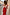 Thumbnail for Red Celestial Midi Dress featuring a cream celestial print, V-neckline and ruffled sleeves on a street.
