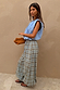 Blue check balloon trousers with a relaxed draped silhouette and elasticated waist, styled with a striped top.