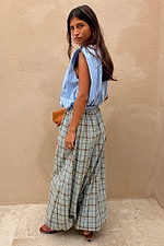 Blue Check Balloon Trousers featuring a relaxed draped silhouette, styled with a blue striped sleeveless top.