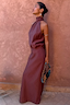 Chocolate Daphne Skirt in a high-waisted straight fit, styled with a matching co-ord top against a clay wall.