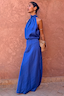Thumbnail for Cobalt Daphne Skirt co-ord with a matching high-neck top and leopard print clutch against a terracotta wall.
