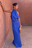 Thumbnail for Cobalt Daphne Skirt and matching halter top co-ord in blue, worn by a model leaning against a terracotta wall.