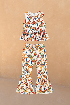 NFD Girl's cream cotton co-ord with a multicoloured banana print, featuring a peplum top and flared trousers.