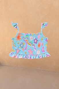Girl's blue smocked Starburst bikini top featuring colourful motifs, frill straps and a ruffled hem.