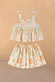 Girl's Starburst Skirt Co-ord Set in blue cotton with a peplum tie-strap top and tiered sun and star print skirt.