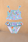 Girl's Starburst Crop Bikini Set featuring a blue smocked top and ruffle-waisted bottoms with a colourful star print.