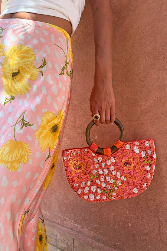 Coral Fawn Beaded Bag with iconic poppy and deer print in glass bead embroidery, featuring a circular wooden handle.