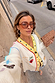 Cream Celestial Martha Cardigan in a soft touch knit with colourful embroidery and yellow trim, styled on a city street.