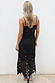 Black Star Sasha Dress viewed from the back, featuring sheer star lace panels and a midi hemline.