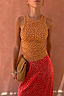 Fawn Rib Tank Top in tan ribbed fabric with white spots, styled with a red patterned skirt and a brown clutch.