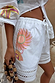 White cotton Dreamer Ellie Shorts featuring sun and eye motifs, a drawstring waist and cut-out hem detail.