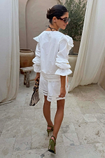 White Dreamer Ellie Shorts with cut-out hem and sun motifs, styled as a cotton co-ord for a summer vacation look.