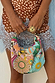 Dreamer Bag with multicoloured glass bead embroidery, sun motifs and a metal bar handle, held by a model.