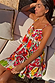White Fruit Stamps Mini Dress with a vibrant Mediterranean print, tiered silhouette and red tassel ties.