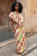 Fruit Stamps Florence Top in cream cotton linen with asymmetric ruffles and side ties, styled as a co-ord.