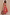 Thumbnail for Pink Fruit Stamps Skirt with a Mediterranean fruit print, shirred waistband and side split on a model.