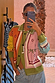 Geometric Palm Cardigan in green with multi-coloured jacquard motifs and blanket stitch detailing in a mirror selfie.