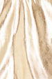 Close-up of metallic gold vegan leather texture for the Gold Mini Jaspre Wrap Skirt.