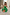 Thumbnail for Multi-wear Green Lola Mid-axi Dress with a ruched strapless bodice and cotton skirt, styled with an orange patterned bag.