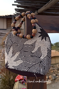Soleil Beaded Bag hand-embellished with chocolate brown and cream beads, featuring circular raffia and wooden handles.