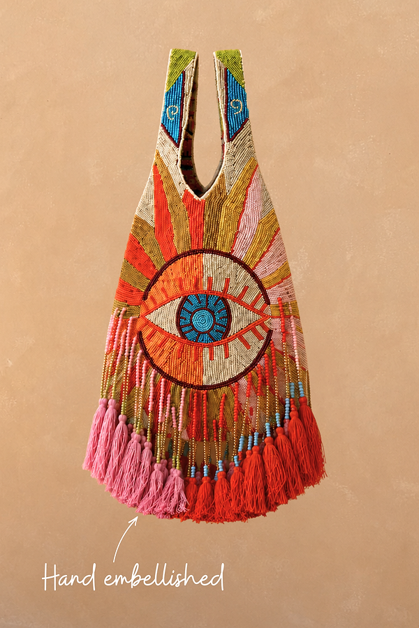 Dolce Vita Eye Bag featuring hand-embellished glass beads, a central eye motif, and pink and red tassels.