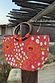 Coral Fawn Beaded Bag with hand-embellished glass bead poppy and deer motifs and circular wooden handles.