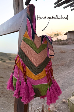Hand-embellished Abstract Beaded Fringe Bag with green glass bead stripes and pink tassels in an outdoor setting.