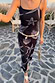 Black Seashell Mesh Cami Dress with starfish prints, styled with a shell beaded belt and gold bag for a vacation look.