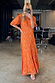 Orange jacquard Bibi maxi dress with gold diamond details and puff sleeves, shown in a studio mirror selfie.