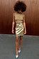 Metallic Gold Vegan Leather Mini Wrap skirt styled with a sleeveless top and light blue heels.