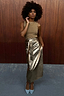 Iconic Gold Vegan Leather Jaspre Skirt styled with a metallic top and light blue pointed heels.