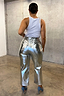 Silver metallic vegan leather trousers seen from behind, featuring back pockets and styled with a white top.