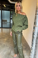 Khaki Vegan Leather Trousers styled with a green pleated off-the-shoulder top with gold metallic spots.