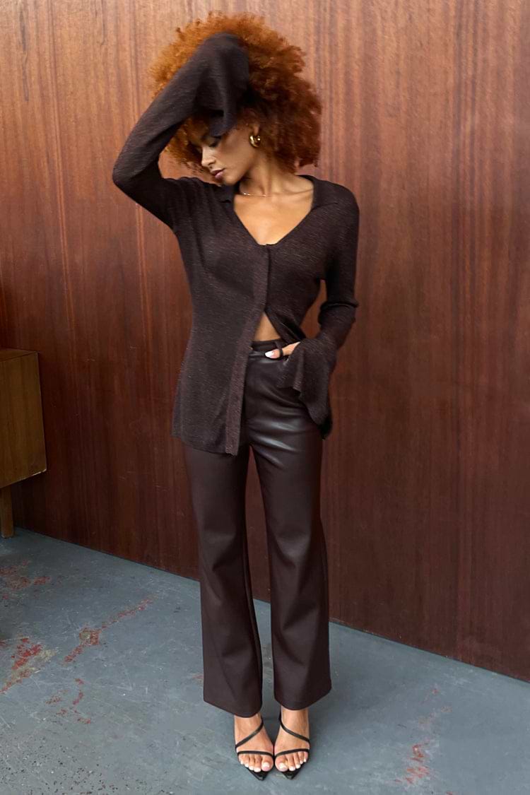 High-waisted brown vegan leather trousers with a straight leg, paired with a chocolate brown knit top.