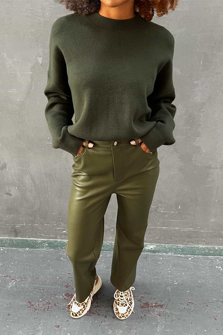 Khaki Vegan Leather Trousers with a dark green jumper and leopard print trainers.