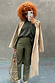 Khaki Vegan Leather Trousers paired with a beige trench coat and leopard print bag for a London look.
