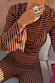 Chocolate and black stripe ribbed top with layered bra detail, flared sleeves and matching trousers.