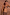 Thumbnail for Ribbed chocolate and black stripe bra top and matching trousers on a model against a textured wall.