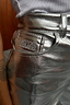 Silver Vegan Leather Trouser featuring a metallic finish and embroidered emblem on the pocket.