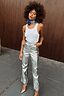 Silver Vegan Leather Trousers styled with a white tank top and blue neck scarf for a street-style look.
