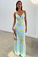 Blue Fawn Poppy Elsie slip dress with yellow poppy and fawn spot prints, styled with a beaded bag.