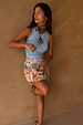 Ice blue ribbed tank top in a soft stretch fabric, styled with a beaded mini skirt and a gold sun necklace.