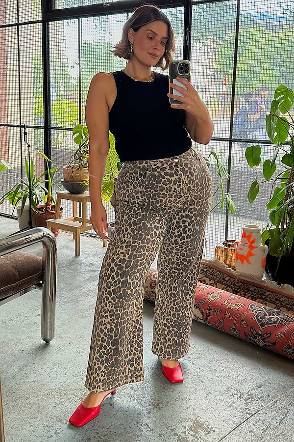 Leopard Lucia Scallop Detail Jeans styled with a black tank top and red heels for an inclusive London look.