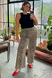 Leopard Lucia Scallop Detail Jeans styled with a black tank top and red heels for an inclusive London look.